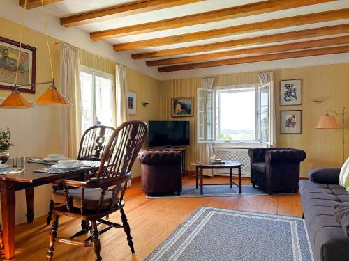 a living room with a table and chairs and a couch at Altes Forsthaus Boppard in Boppard