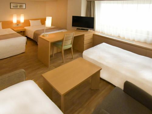 Ένα ή περισσότερα κρεβάτια σε δωμάτιο στο Sapporo View Hotel Odori Park