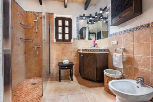 a bathroom with a shower and a sink and a toilet at Coster Puig in Pollença