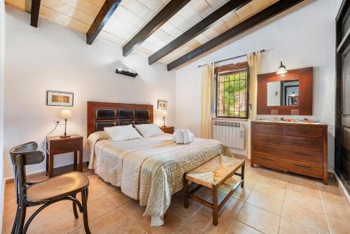 a bedroom with a bed and a desk and a sink at Coster Puig in Pollença