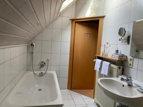 a bathroom with a tub and a sink at Ferienwohnung an der Brigach in Donaueschingen