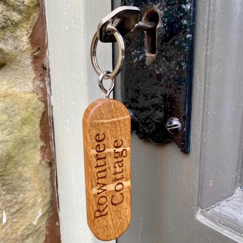a key tag on a door handle on a door at Grove House Levisham in Pickering