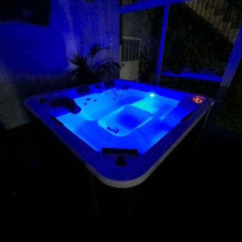 a blue bathtub in a room with a dark room at SOSTA CAMPER PARK Cilento con piazzole e Tende in Ogliastro Cilento