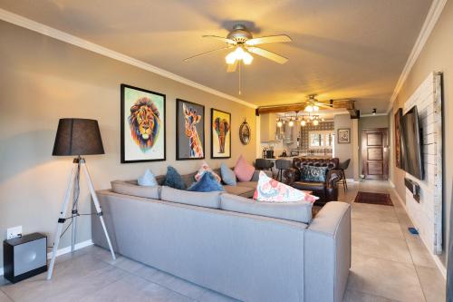 a living room with a couch and a ceiling fan at La Pirogue 14 in Ballito