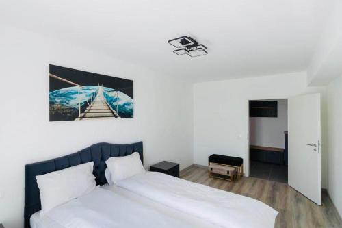 een slaapkamer met een bed en een foto aan de muur bij Dominic Apartments Sighisoara in Sighişoara