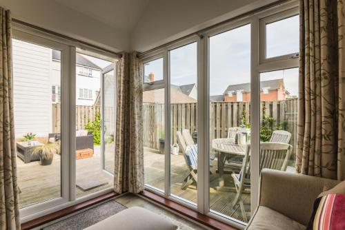 a screened in porch with sliding glass doors at Pebbles in Camber