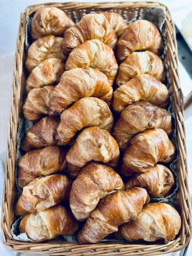 a basket filled with croissants on a table at Hotel Auwirt Zentrum in Saalbach Hinterglemm