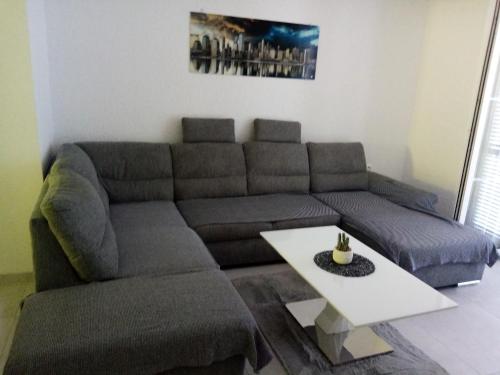 a living room with a couch and a table at Natalija apartmani in Sveti Juraj