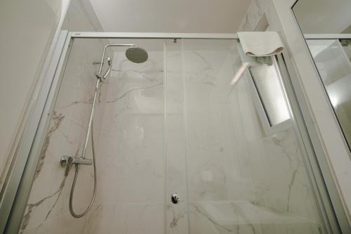 a shower with a glass door in a bathroom at Villa Yvonne in Ostend