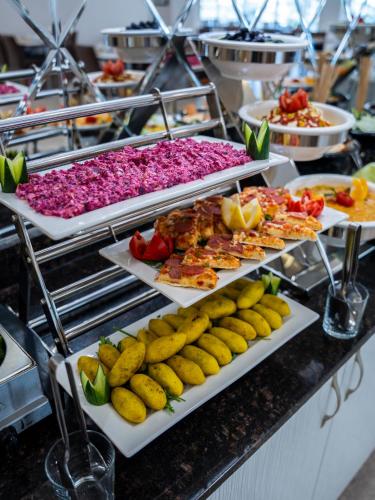 a buffet with many plates of food on a counter at Parwar Hotel in Duhok