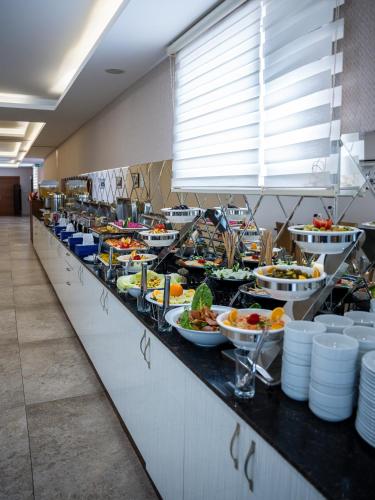 a buffet line with many plates of food on it at Parwar Hotel in Duhok