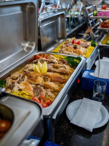 a buffet with many different types of food in trays at Parwar Hotel in Duhok