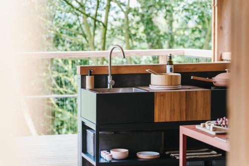 a kitchen with a sink and a window at RewildThings Treehouses in Gloucester