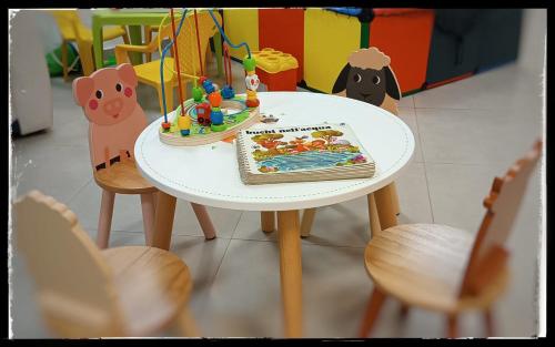 a white table with a birthday cake and chairs at Alma di Alghero Hotel in Alghero