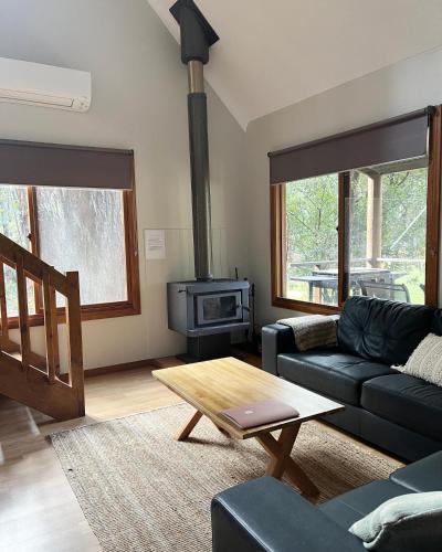 a living room with a couch and a stove at Noble River Estate in Dwellingup