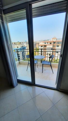 a view of a balcony with a table and chairs at Disy Apartments in Vlorë