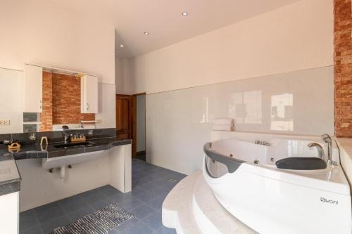 a large bathroom with a tub and a sink at Luxury Villa a unique Paradise directly on the Sea in Mormol