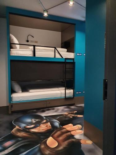 a room with two bunk beds with a poster on the floor at Stardust Boutique Hotel in Hua Hin