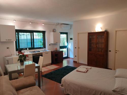 a kitchen and living room with a couch and a table at Ampio monolocale nel cuore di Pesaro in Pesaro