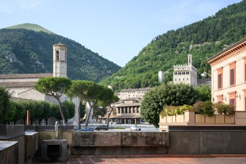 a view of a city with a mountain in the background at Hotel San Marco in Gubbio