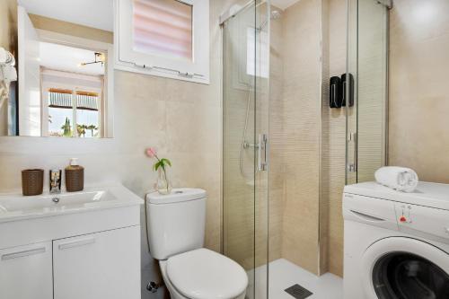 a bathroom with a toilet and a glass shower at Vistamarina A309 By IVI Real Estate in Torremolinos
