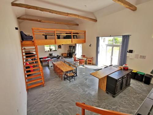 a room with a loft bed and a living room at A l'Orée du Lac, 500m lac de Chamboux in Saint-Martin-de-la-Mer