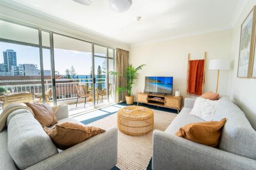 a living room with two couches and a television at Ocean View 2BR Apartment and SPA in Gold Coast