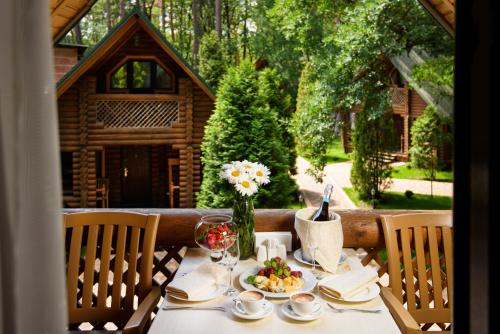 a table with a plate of food and flowers on it at Фортеця in Kyiv