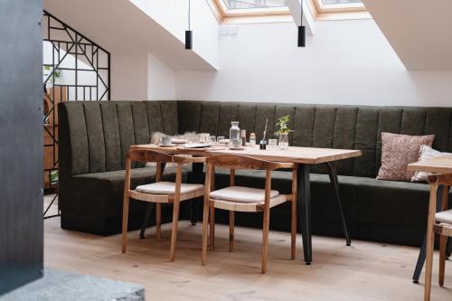 a table and chairs in a room with a couch at Grand Pension Franziska - inkl CrossFit Gym in Saalbach Hinterglemm