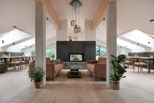 uma sala de estar com sofás e uma lareira em Grand Pension Franziska - inkl CrossFit Gym em Saalbach-Hinterglemm