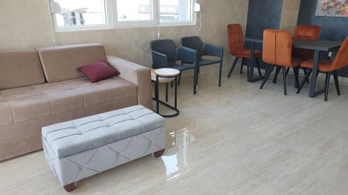a living room with a couch and a table and chairs at APARTMAN 5 BMB in Veliko Gradište