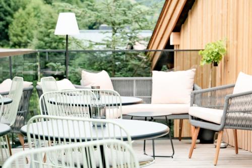 a row of chairs and tables on a balcony at Grand Pension Franziska - inkl CrossFit Gym in Saalbach Hinterglemm