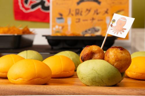 a bunch of apples and oranges with a sign on them at Hotel the Lutheran in Osaka