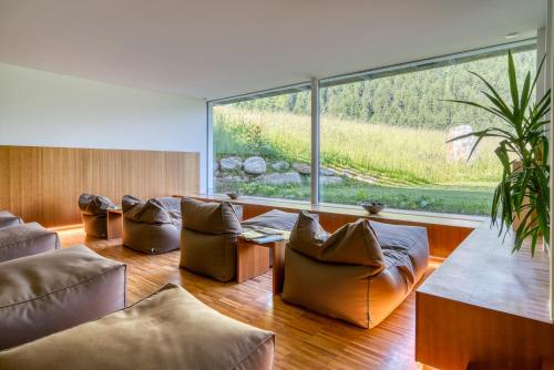 a living room with leather furniture and a large window at Hotel Cevedale in Solda