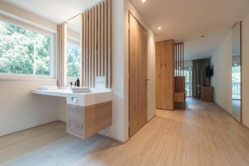 a bathroom with a sink and a large window at Anett hotel in Vipiteno