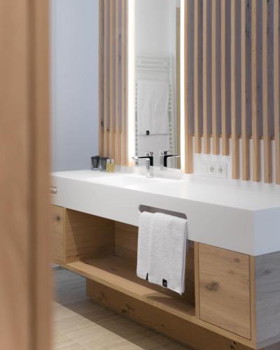 a bathroom with a white sink and a mirror at Anett hotel in Vipiteno