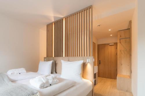 a bedroom with two beds with white pillows at Anett hotel in Vipiteno