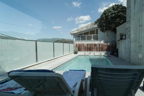 a swimming pool with a view of the ocean at Refúgio da Cabreira in Vieira do Minho