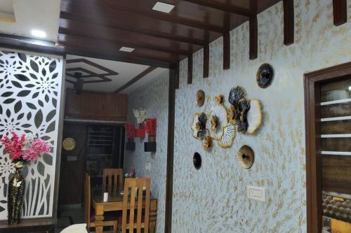 a dining room with a wall with plates on it at Luxurious 3 BHK Flat in Ghaziabad in Ghaziabad