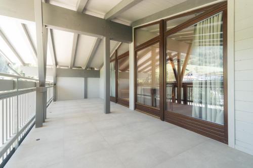an empty corridor in a building with glass windows at Anett hotel in Vipiteno