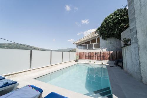 a swimming pool on the balcony of a house at Refúgio da Cabreira in Vieira do Minho