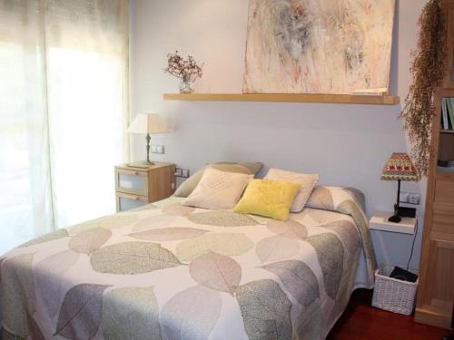 a bedroom with a bed with two pillows on it at Homing Golf Bonmont 12 in Bonmont Terres Noves
