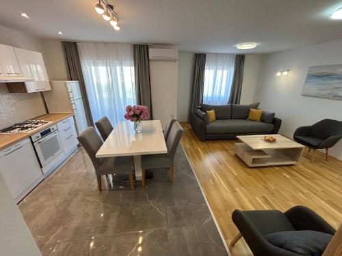 a kitchen and a living room with a table and chairs at Sweet Lapat by EL-PI TOURS in Porat