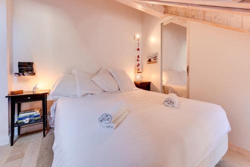 a bedroom with a white bed and a mirror at La Terrasse du vieil Annecy in Annecy