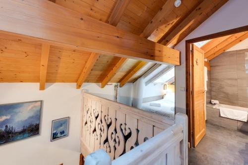 a room with wooden ceilings and a staircase with a mirror at La Terrasse du vieil Annecy in Annecy