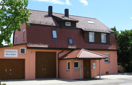 a large house with two garage doors at Gästeapartments Haus Kohler in Abstatt