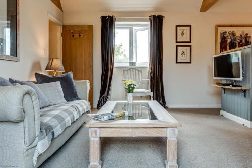 a living room with a couch and a coffee table at Sansoms Loft in Woodstock