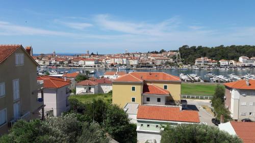 a view of a city with a harbor and buildings at Piadora in Banjol