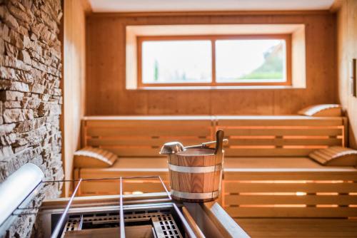 a room with a sauna with a window at Hotel Resmairhof in Schenna