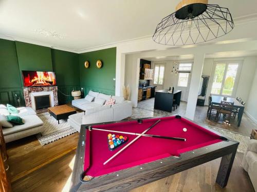a living room with a red pool table in it at Maison de campagne à 2h de Paris in Droué